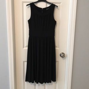 Black sleeveless dress with gathered skirt